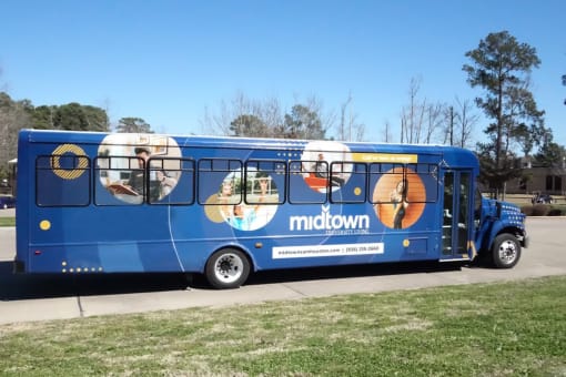 a blue bus at Midtown Sam Houston Apartments, Huntsville