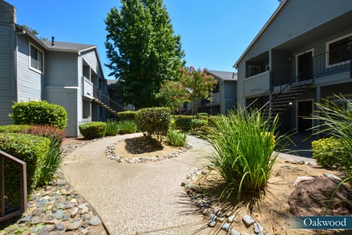 a view of a courtyard between two apartment buildings