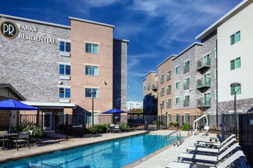 our apartments have a large pool and lounge chairs at Parks Residential - Richardson, Richardson, 75082
