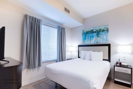 a bedroom with a large white bed and a window at Parks Residential - Richardson, Texas, 75082