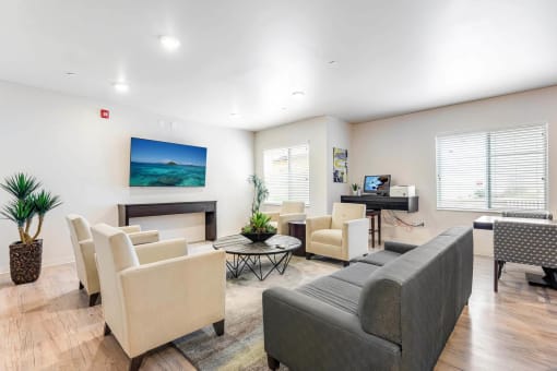 a living room with couches and chairs and a television at Parks Residential - Denver, Centennial Colorado