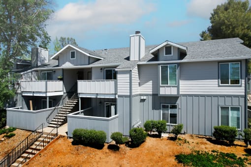 a large gray house with a gray roof