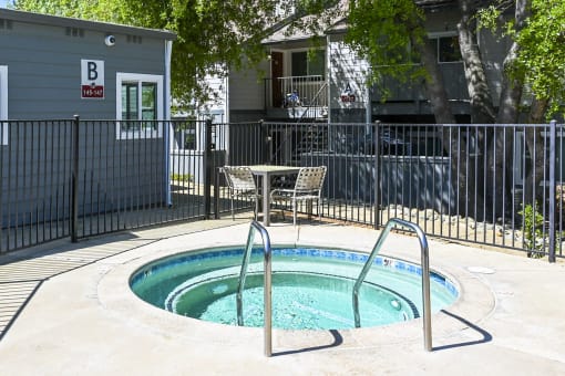 a hot tub with a table and chairs next to it