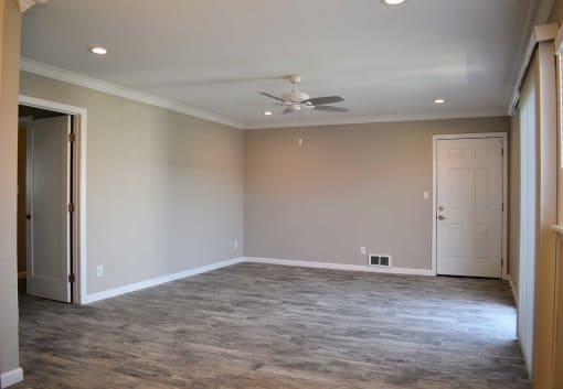 View of living area with wood like flooring and ceiling fan