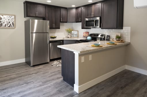 a kitchen with a large island and stainless steel appliances