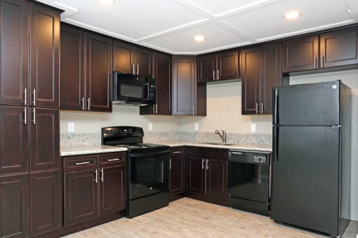 Kitchen with black appliances and granite counter tops