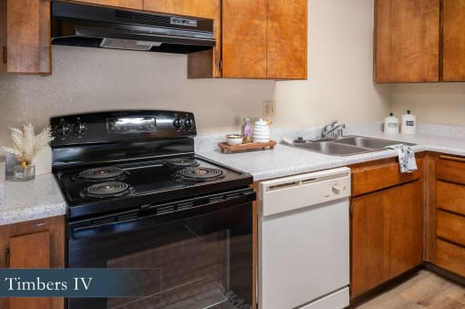 a kitchen with a black stove and a white sink