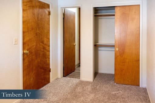 a hallway with two doors and a closet
