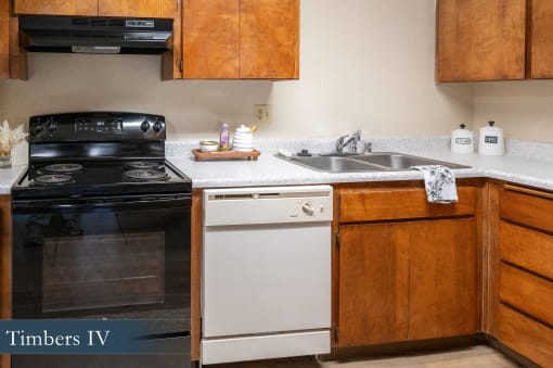 a kitchen with white appliances and wooden cabinets and a sink