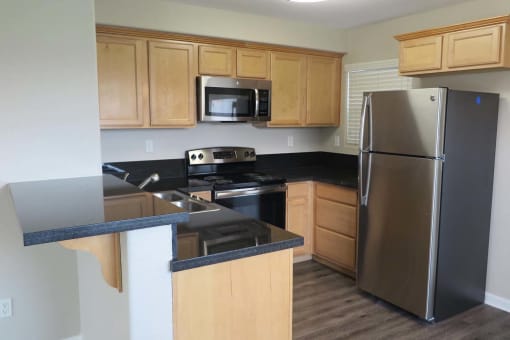 view of kitchen with light colored cabinets and stainless appliances