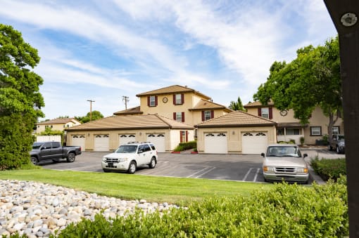 abuilding at Tuscana with two garages and two cars parked in the driveway