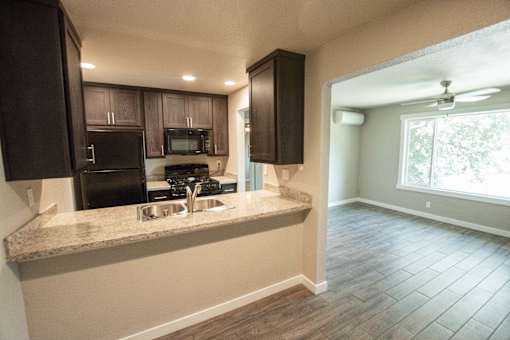 a kitchen with a large window and a counter with a sink