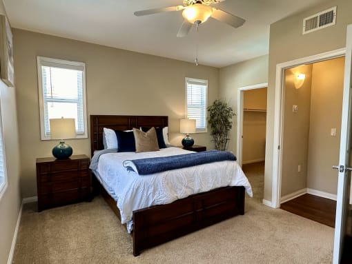 a bedroom with a large bed and a ceiling fan