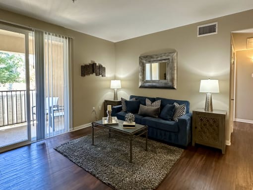 a living room with a blue couch and a coffee table