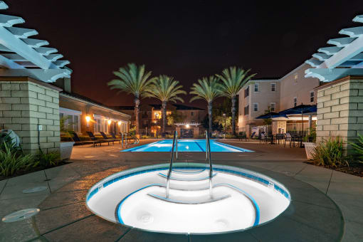 a pool with ahot tub at night at Vista Pointe