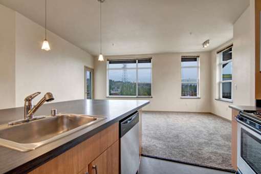 A kitchen with a sink, dishwasher, and oven.