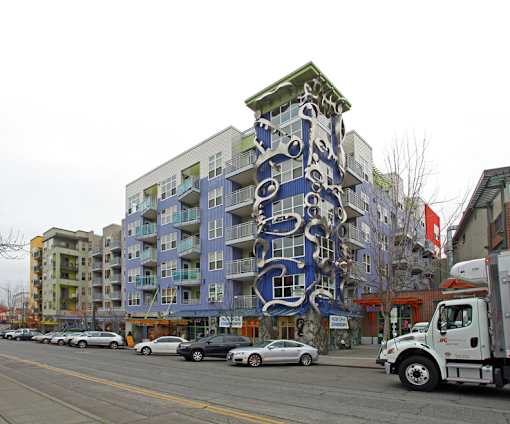A large blue and white building with a face on it.