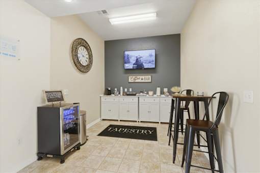A room with a bar and a TV on the wall.