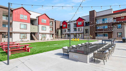 A red and white building with a patio and chairs.
