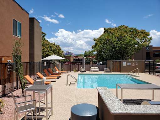 Resort style pool with lounge chairs and spa at Pinon Lofts Apartments, Sedona, Arizona