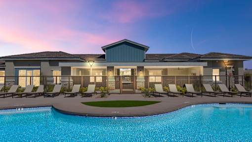 A modern house with a swimming pool in front.