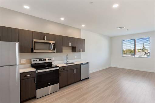 A modern kitchen with wooden cabinets and stainless steel appliances.at The 89 on Hayden, Arizona  