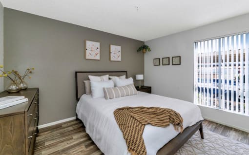 a bedroom with a large bed and a window  at Glen Brae, Glendale, AZ