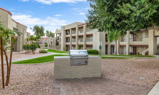 an outdoor area with a grill in front of an apartment building at Glen Brae, Arizona