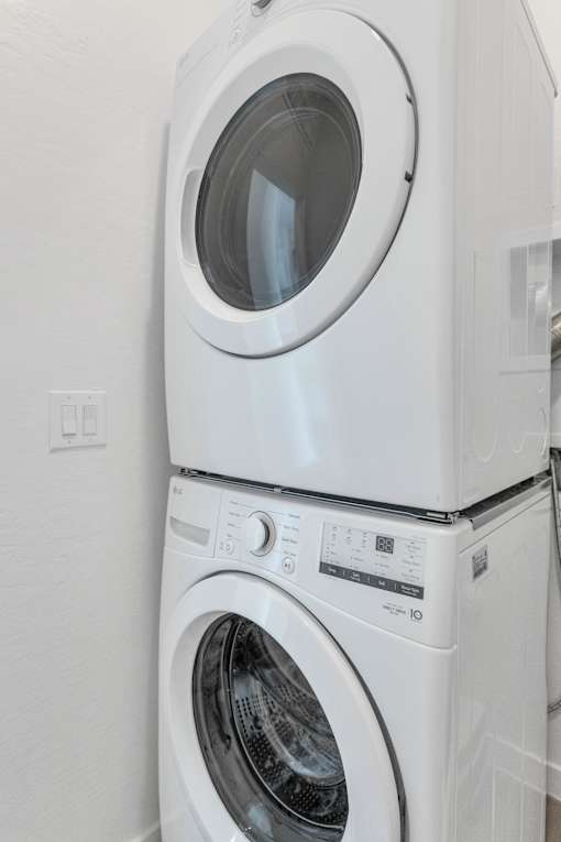 A white washing machine and dryer stacked on top of each other at Marketside Villas at Verrado, Buckeye, AZ