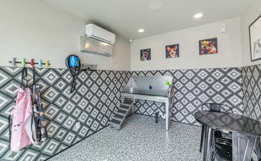 A room with a patterned wallpaper and a table with chairs at Marketside Villas at Verrado, Buckeye, AZ