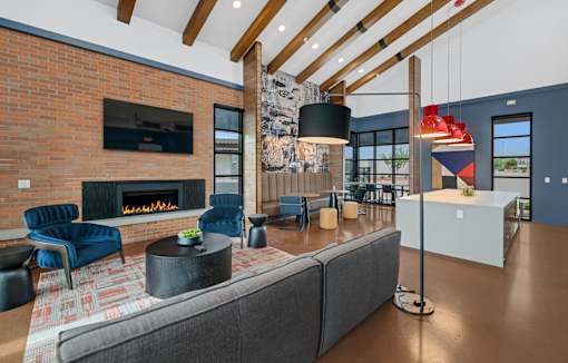 A modern living room with a fireplace and a grey sofa at Marketside Villas at Verrado, Buckeye, AZ