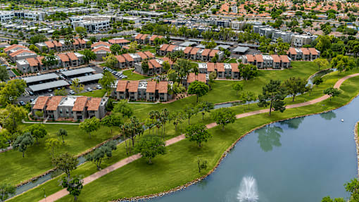 A residential area with houses and a fountain.