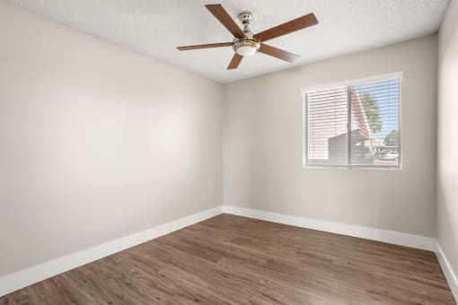 an empty room with a ceiling fan and a window at Denim Scottsdale, Scottsdale
