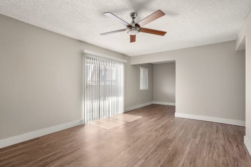 an empty living room with a ceiling fan at Denim Scottsdale, Scottsdale, AZ