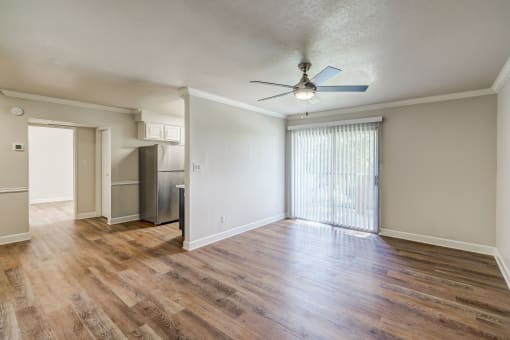 an empty living room with wood flooring and a ceiling fan at Denim Scottsdale, Scottsdale, AZ