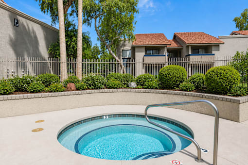 A small round pool with a metal railing around it.
