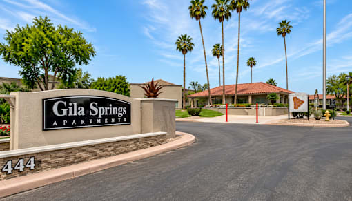 The entrance to Gila Springs Apartments is marked by a large sign.