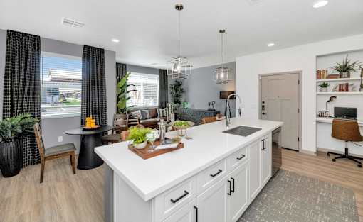 A modern kitchen with white cabinets and a large island.