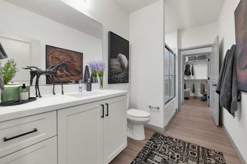 A bathroom with a white toilet and a sink.