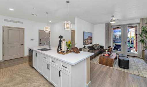 A modern kitchen with white cabinets and a large island.