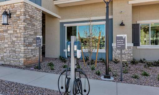 A bicycle is parked next to a charging station for electric vehicles.