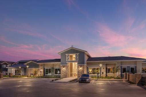 A building with a parking lot in front of it.