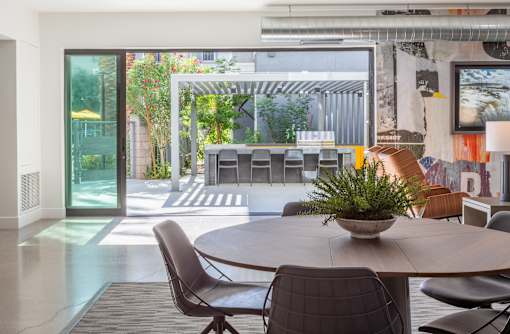 A modern dining room with a table and chairs.