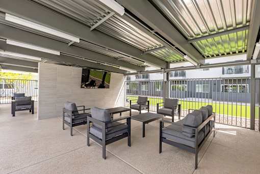 Outdoor lounge area with adjustable shade pergola at Lucero Apartments, Phoenix, AZ 85051