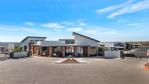 A building with a parking lot in front of it.at Marketside Villas at Verrado, Arizona