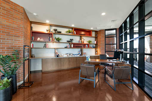 A modern office space with a wooden floor and a brick wall.at Marketside Villas at Verrado, Buckeye, AZ