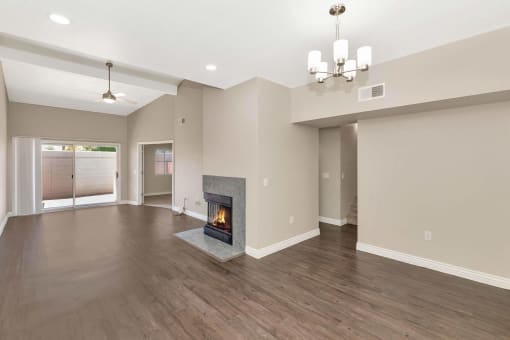 the living room has a fireplace and hardwood floors