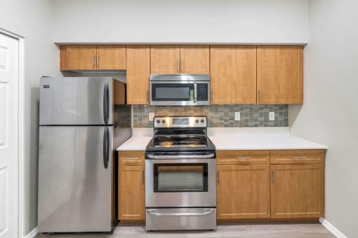 a kitchen with stainless steel appliances and wooden cabinets