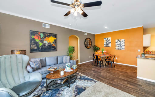 A living room with a grey chair and a wooden coffee table at Montage at Pecos Ranch Apartments, Chandler, AZ, 85286
