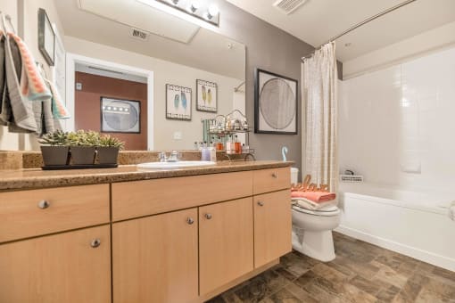 a bathroom with a sink and a toilet at Montage at Pecos Ranch Apartments, Chandler, AZ